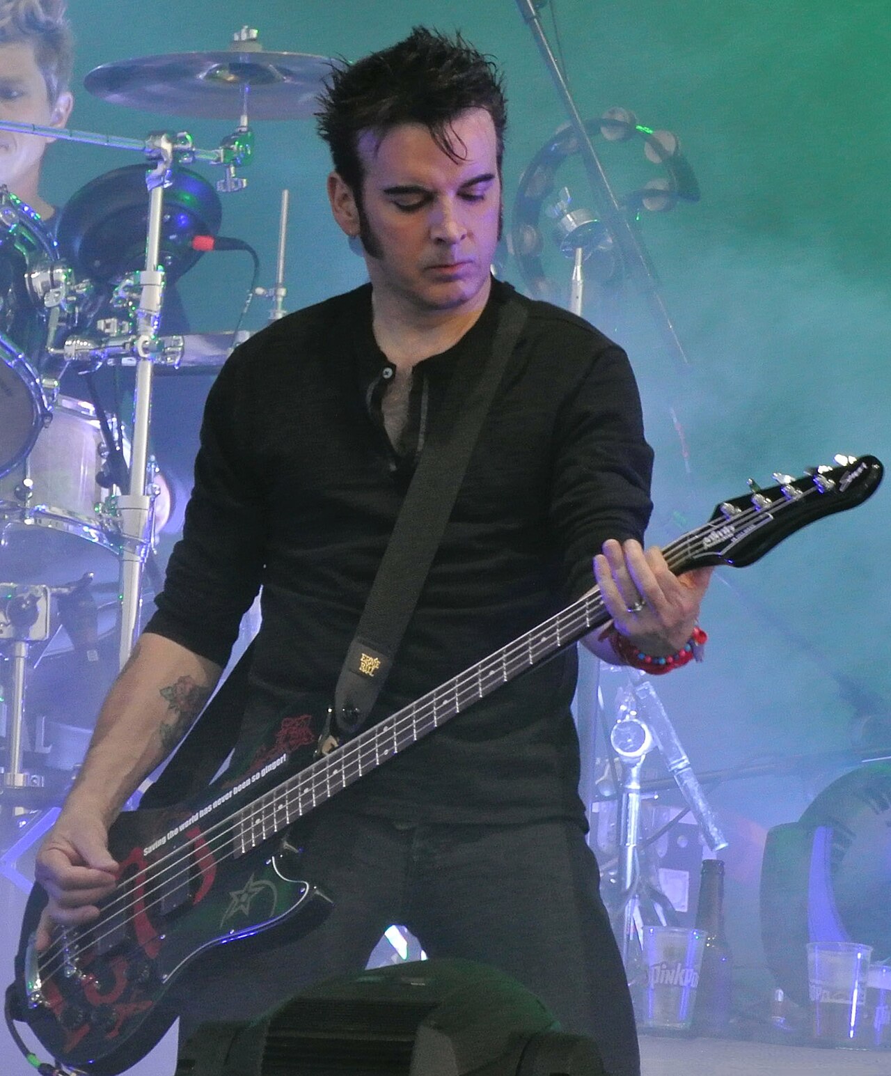 Simon Gallup and Jason Cooper from The Cure in 2012 (cropped).jpg