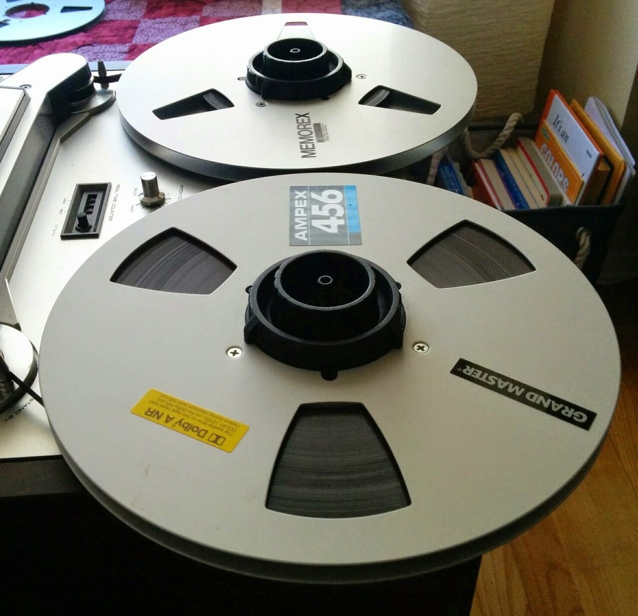 Ampex- and Memorex-branded ten-inch spools with magnetic tape on Akai reel to reel audio recorder.jpg